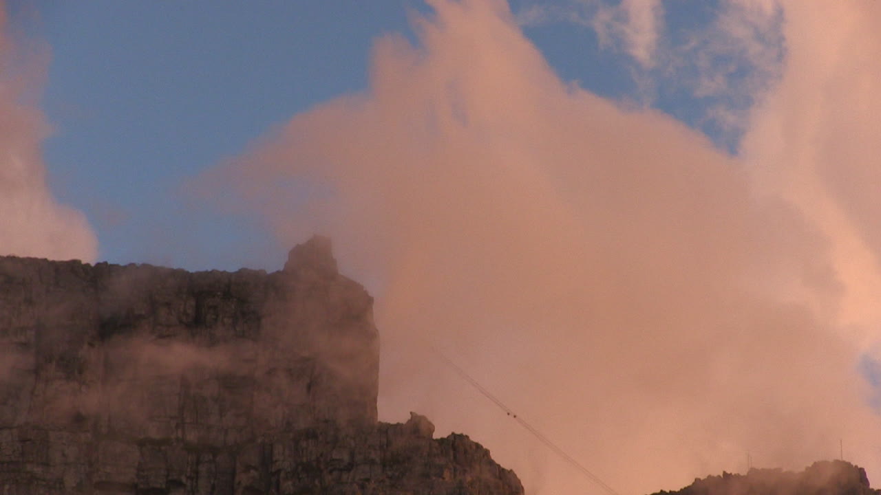 Table Mountain shrouded in clouds at sunset