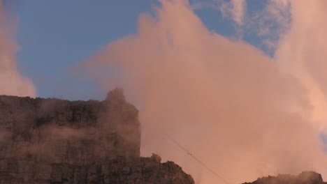 table mountain shrouded in clouds at sunset