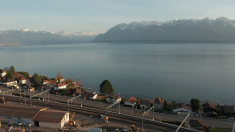 aerial of highway at the edge of beautiful lake