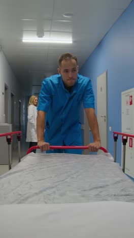 hospital corridor with nurse pushing a bed