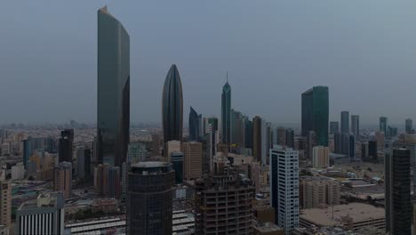 drone 4k shot of kuwait city skyline showing modern high-rises and dense architecture. ideal for themes on urban growth, middle east development, construction, and real estate visuals.