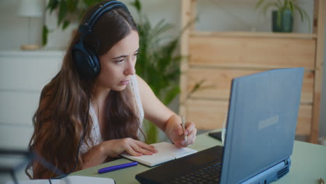 conference call woman taking notes headphones