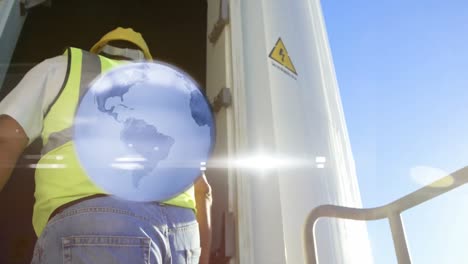 animation of globe over engineer and wind turbine in countryside