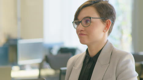 Senior Businessman Speaking with Young Female Colleague
