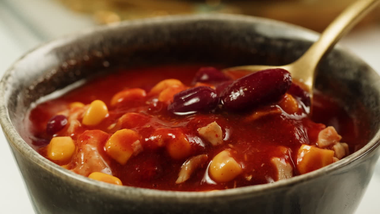 Indulge in a wholesome dinner with kidney beans, white rice, and a soothing soup in a warm and inviting atmosphere