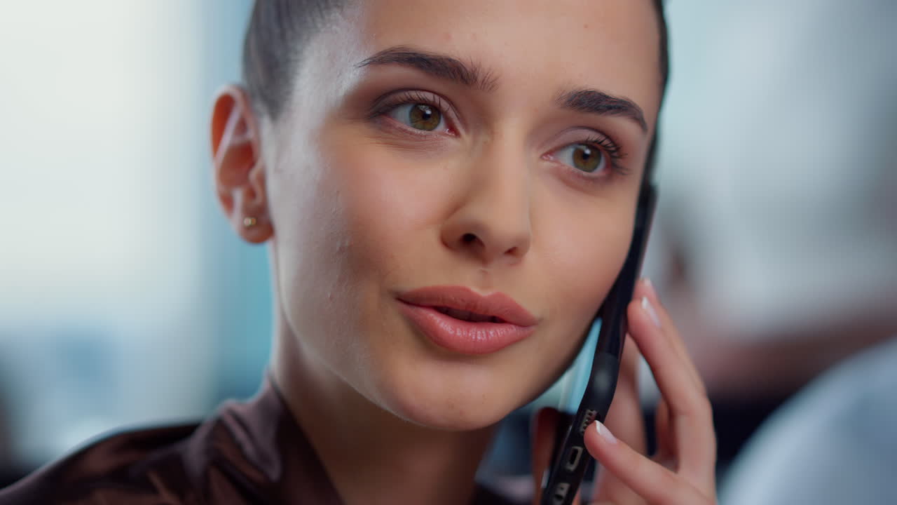 Businesswoman face talking on smartphone. Employee having phone conversation