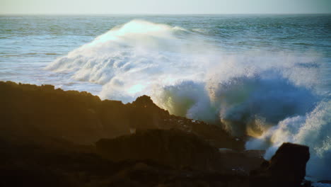 dramatic ocean rolling coastline at sunrise slow motion. powerful foaming waves