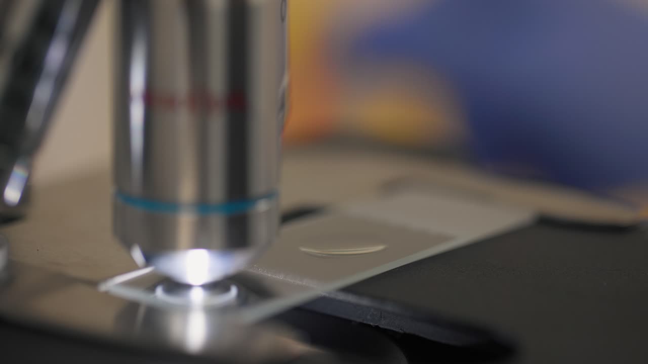 Clinician dropping liquid for the microscope