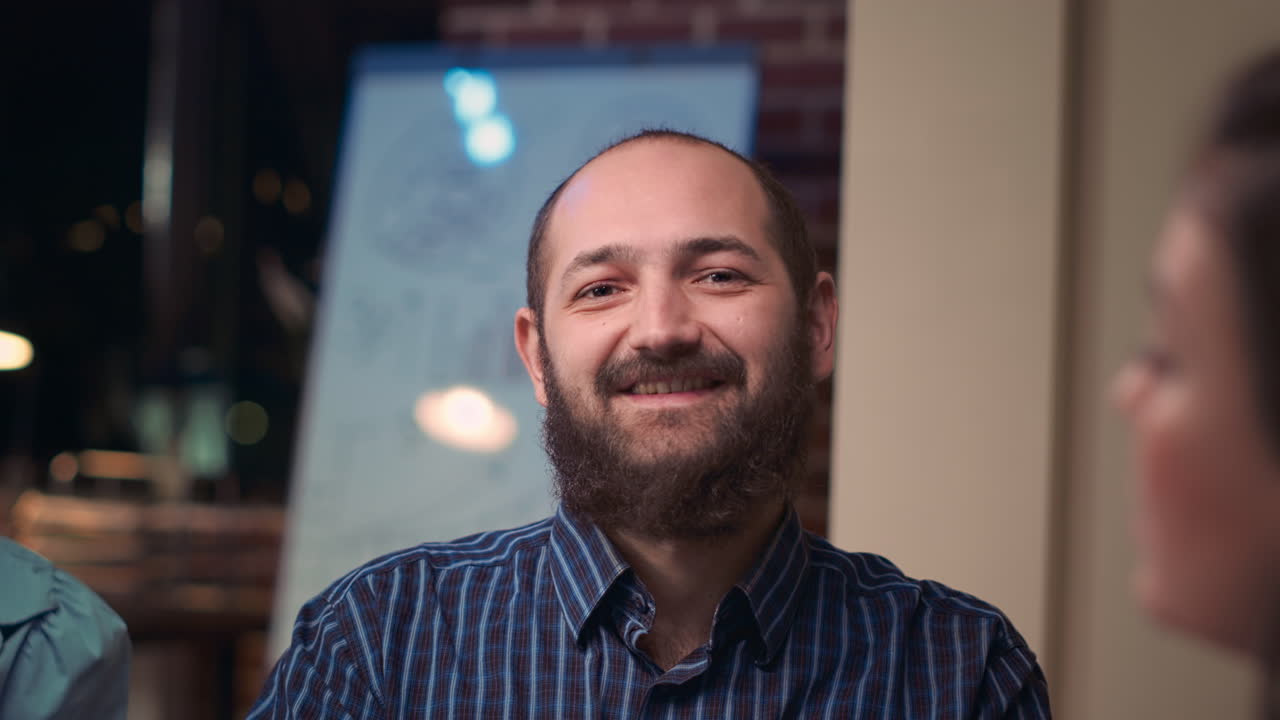 Employee looking at camera in business meeting, smiling