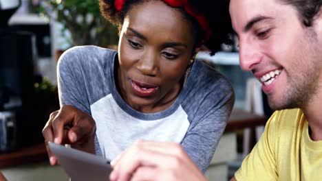 man and woman interacting over digital tablet