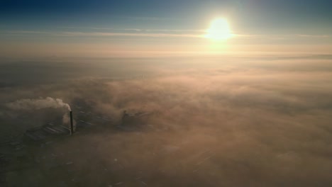 aerial drone shot above urban townscape areas shrouded in morning mist