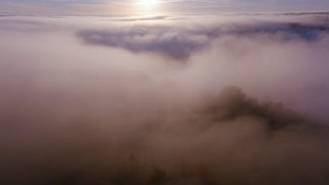 the first sun rays pierce a dense layer of clouds in a golden dawn glow.