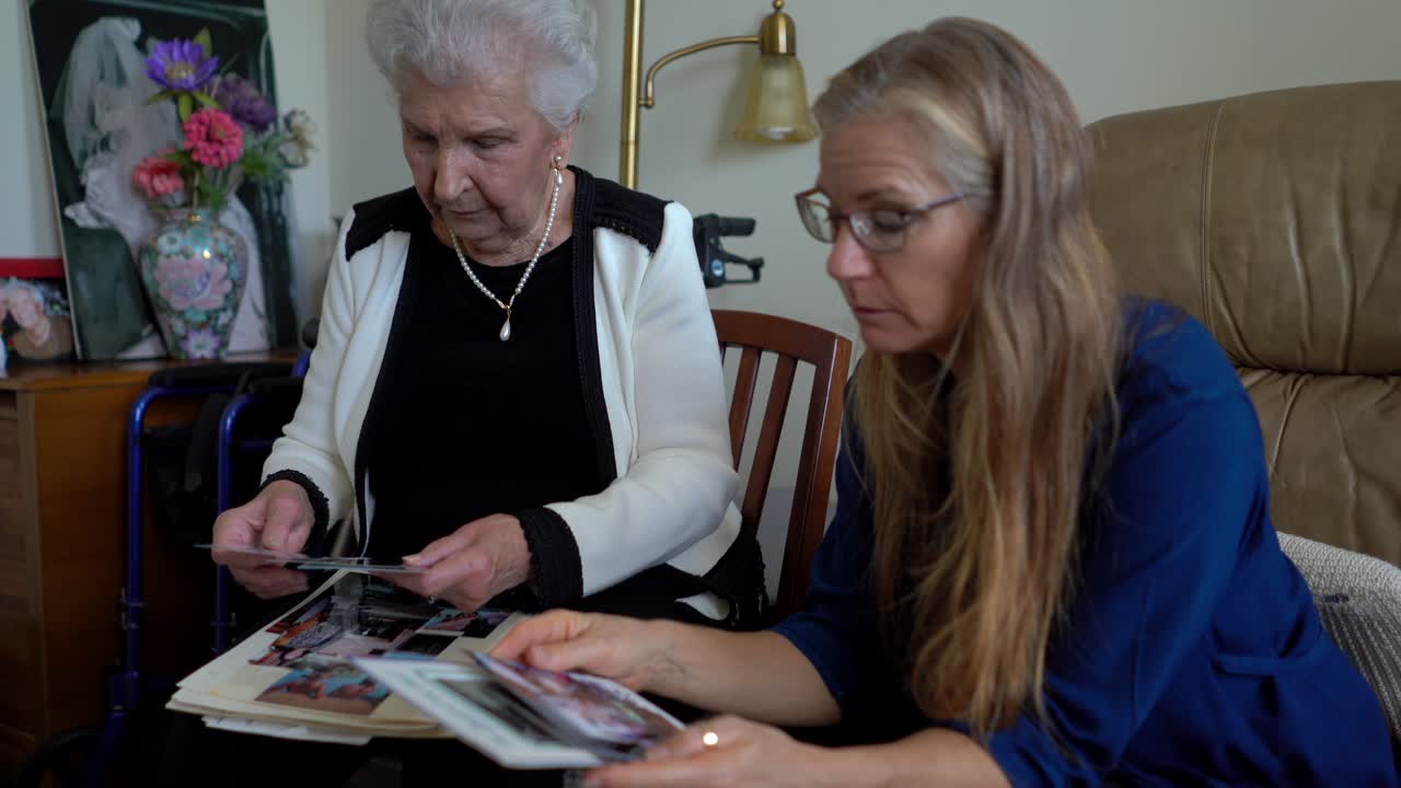 Two Women Looking at Old Photographs