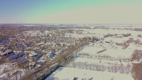 aerial drone view of the snowy landscape at the suburban in the netherlands