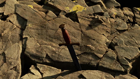 excalibur sword in rocky stone at sunset