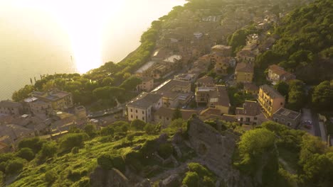 cinematic aerial view above orsinis fortress in trevignano romano, lazio, italy