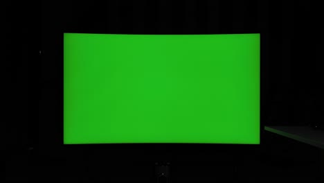 422 10 bit static shot, curved tv green screen at night in a dark room with ambient lighting