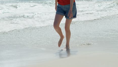 Woman-walking-on-beach-on-a-sunny-day-4k