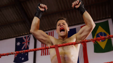 excited male boxer posing after victory