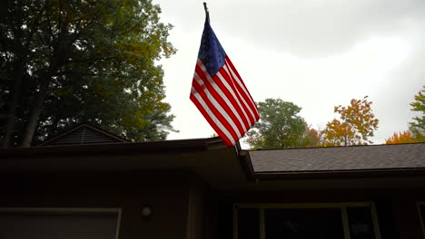 Shot-of-an-American-Flag-blowing-in-the-wind-of-a-fall-storm-in-Michigan,-USA