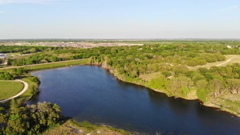 Moving-back-and-panning-right-to-show-the-greenspace-near-a-water-reservoir