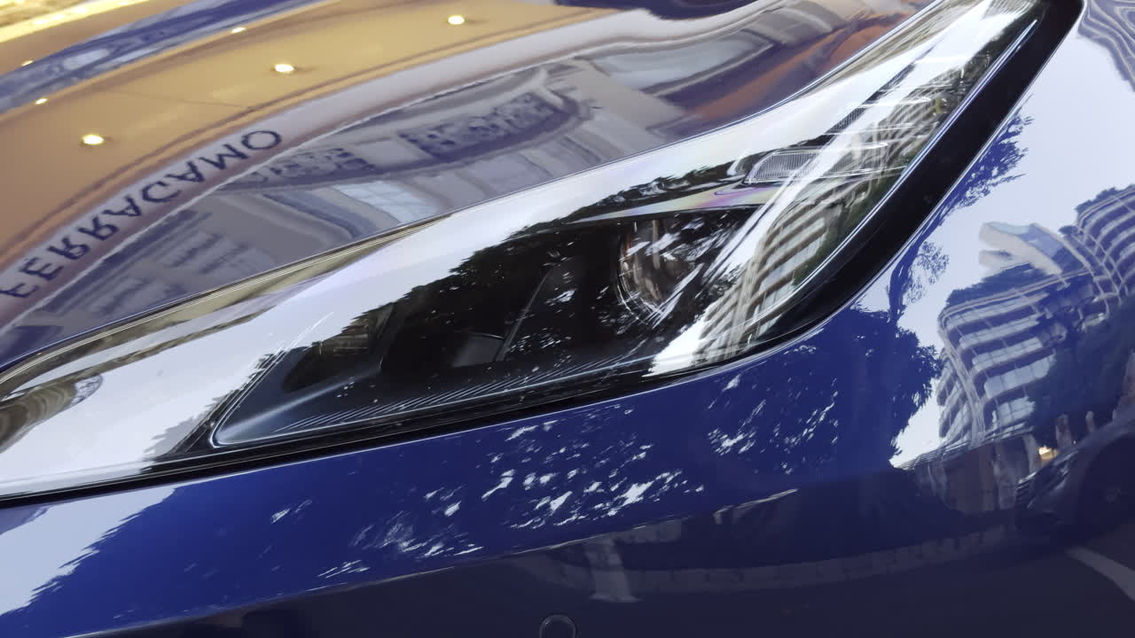 Close-up of a blue sports car's headlights