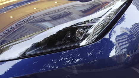close-up of a blue sports car's headlights