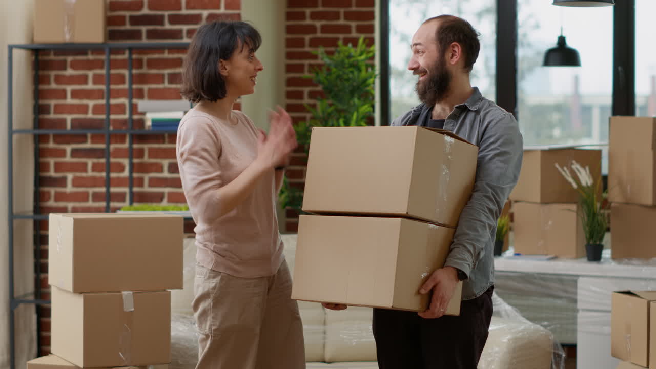 Husband and wife receiving new household keys after buying first home