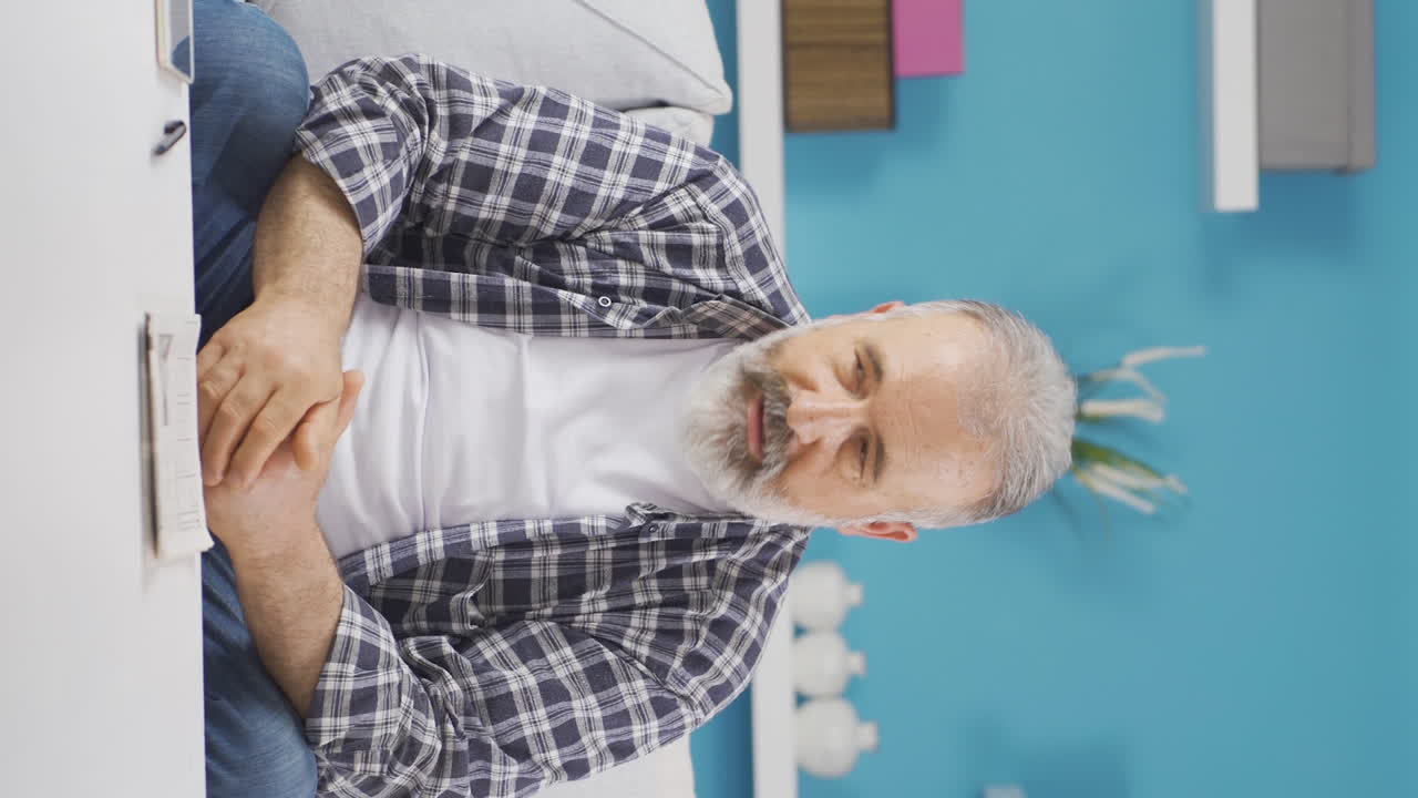 Vertical video of Sad old man is crying.