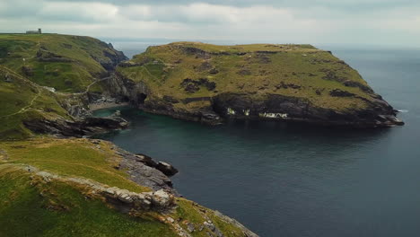 tintagel castle ruins on cornish atlantic coast headland, aerial view