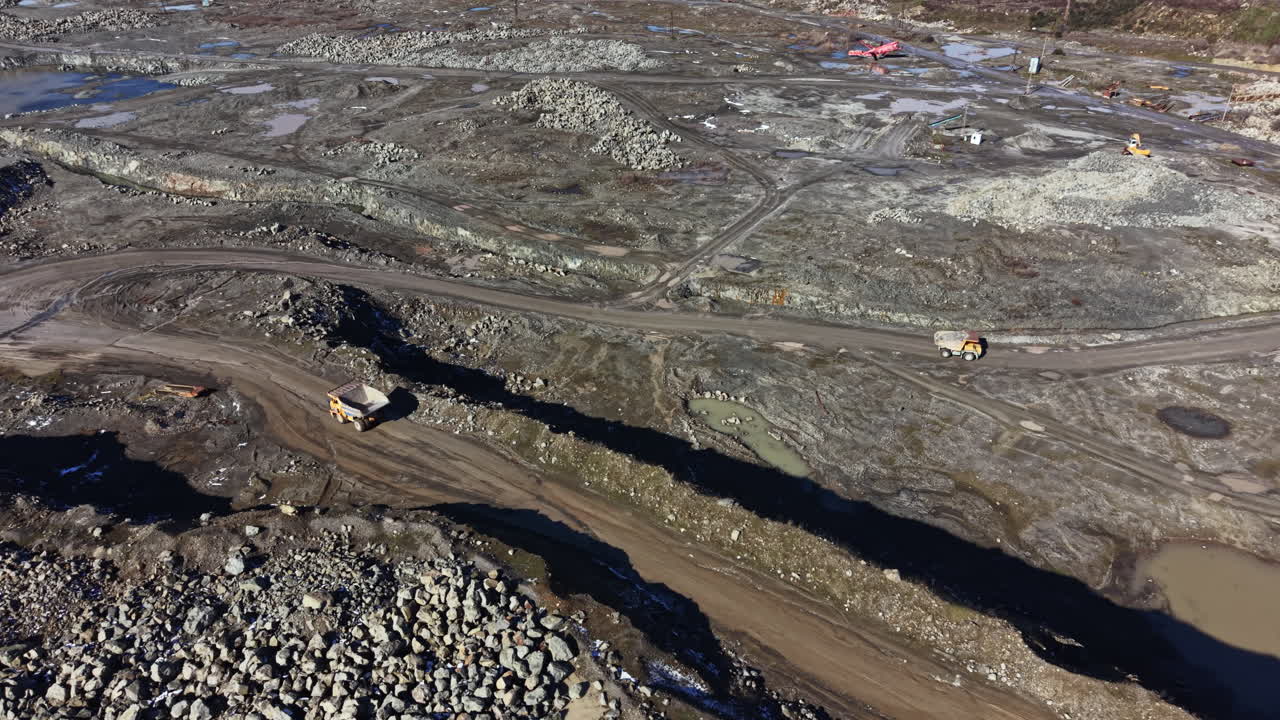 Construction site shows heavy machinery working on land clearing and site preparation for new development in open area