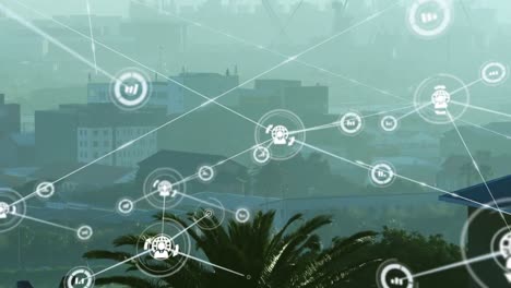 animation of network of digital icons against aerial view of cityscape