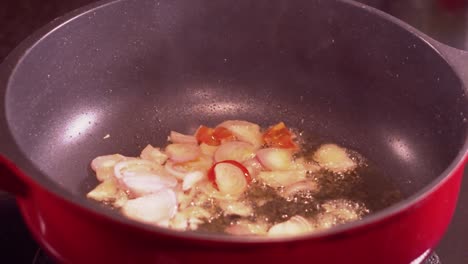 close up video of red onions frying in a pan