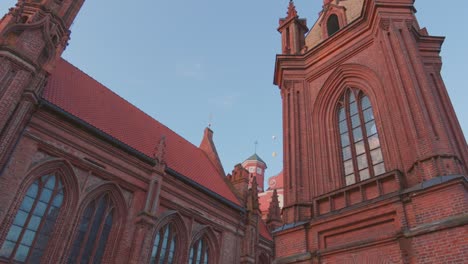 may 29, 2022: vilnius, lithuania. roman catholic church of st. anne and church of st. francis and st. bernard in old town in summer sunny day. unesco world heritage