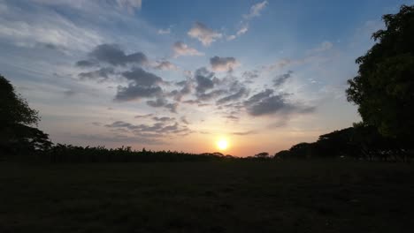 morning sun rises over the plains with scattered clouds in a peaceful time lapse