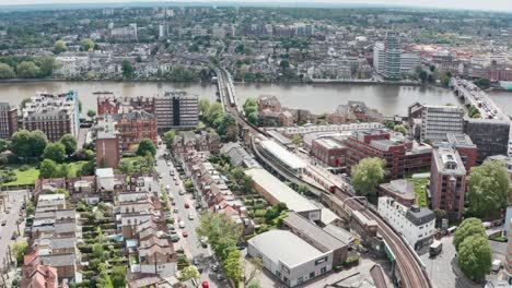 Stationary-aerial-drone-shot-of-Putney-bridge-Tube-station-West-London