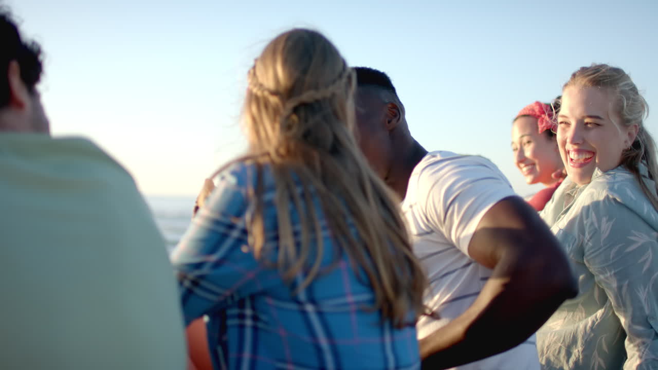 Diverse group of friends enjoying a sunny day outdoors, with clear blue skies