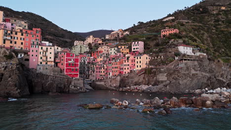 colorful cliffside village in riomaggiore, cinque terre, with vivid buildings by the sea