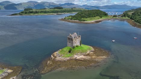 Aerial-drone-video-circling-around-Castle-Stalker-on-a-small-island-on-the-coast-of-Scotland