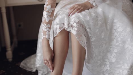 Woman-put-on-wearing-wedding-shoes-on-slim-legs,-bridal-footwear,-morning-dressing-before-ceremony