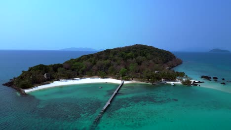 koh kham island with crystal clear turquoise water, white sand beaches and lush tropical vegetation, a popular tourist destination in thailand. best aerial view flight static tripod hovering drone