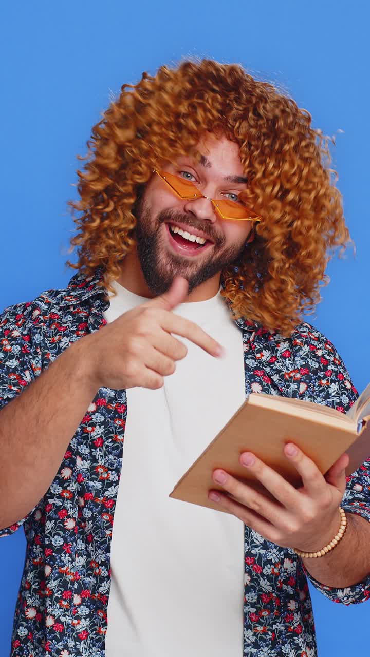 Happy stylish man reading funny interesting fairytale story book leisure hobby learning study