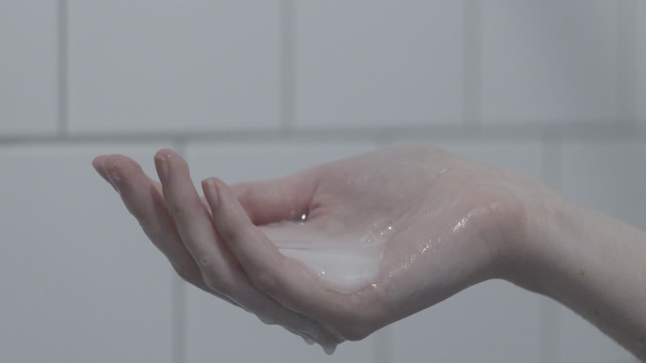 Close-up of a Hand Holding a Gooey White Substance