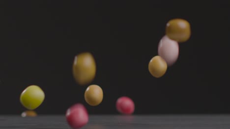 close up shot of colourful candy falling down