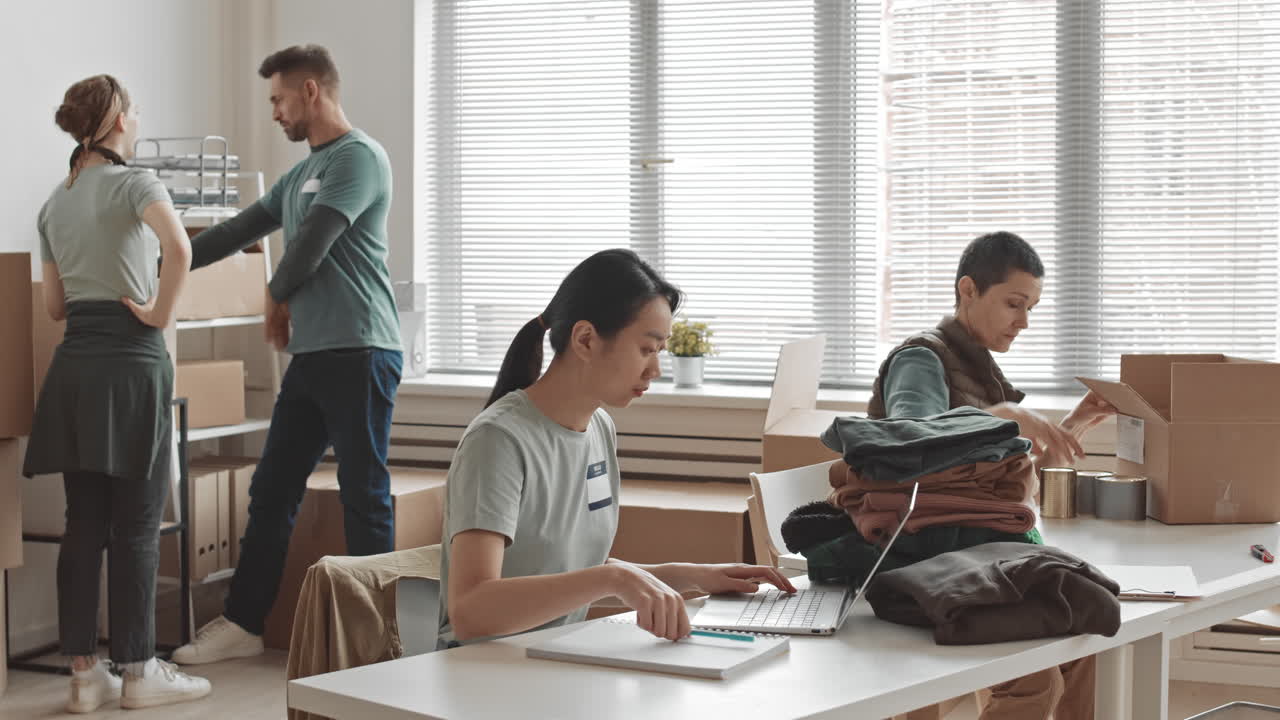 Volunteers packing donations in an office