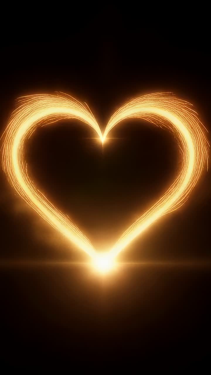 Video verticale: punti luminosi che brillano, formando scie dorate gemelle che creano una forma a cuore su sfondo nero