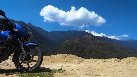 motorcycle in himalayan mountain with cloud time lapse and blue sky at morning from flat angle