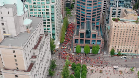 circling drone overhead view of the cancel canada day protest march in vancouver bc canada