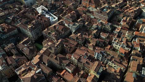 aerial view of venice’s compact residential rooftops and winding canals.