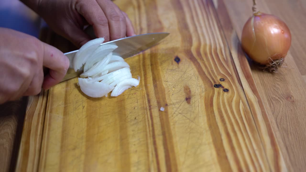 slicing onion chopping into julienne on wooden board kitchen healthy healthy diet